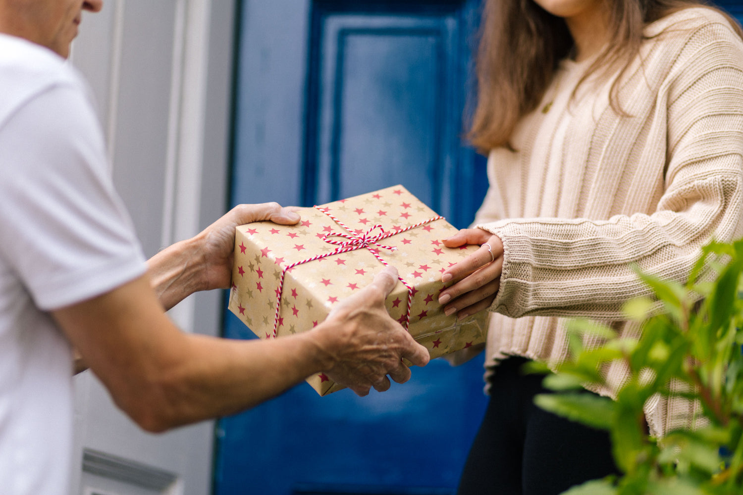 Man handing a woman a gift wrapped box 